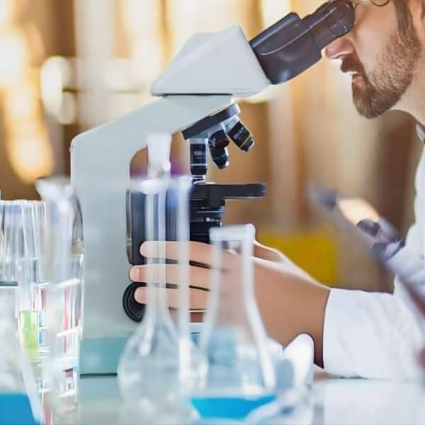 Pet In-House Lab Services A man in a lab coat viewing a sample